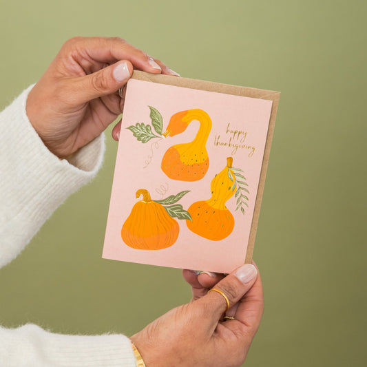 Thanksgiving Gourds greeting card held in hand