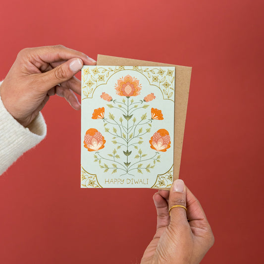 Jaipur Blooms Diwali greeting card held in hand