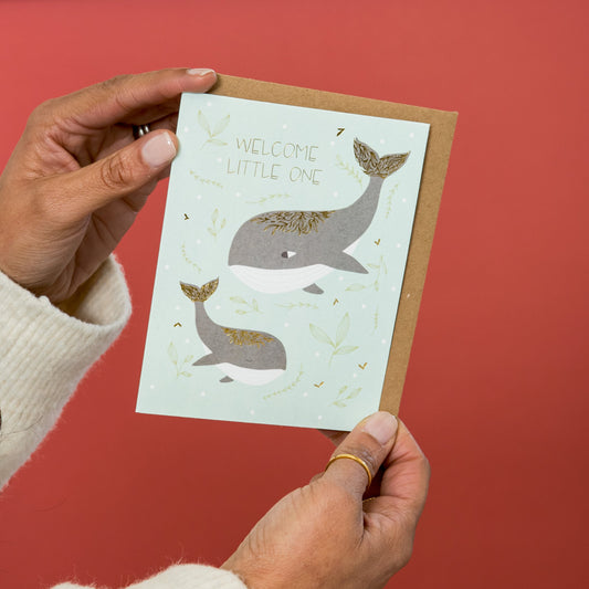 Welcome Little One greeting card held in hand
