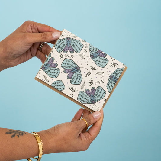 Moth Garden greeting card held in hand