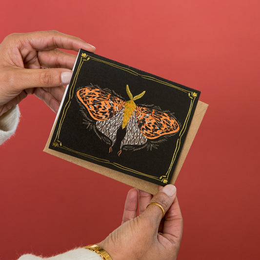 Golden Moth greeting card held in hand
