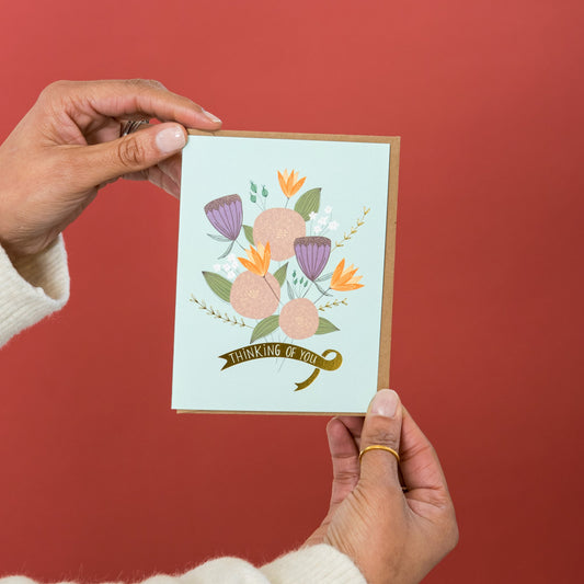 Thinking of You Flowers greeting card held in hand
