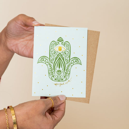 Good Luck Hamsa greeting card held in hand