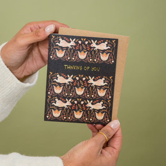 Thinking of You Bunnies greeting card held in hand