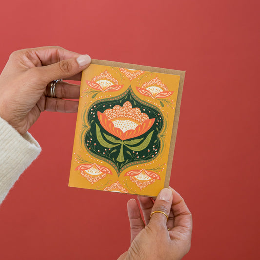 Trellis Blooms greeting card held in hand