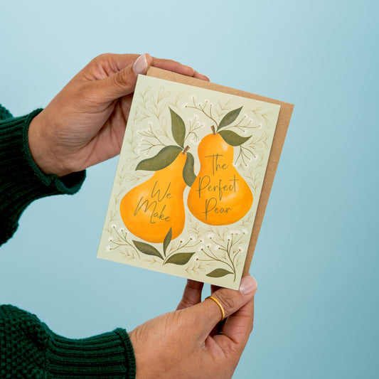 The Perfect Pear greeting card held in hand