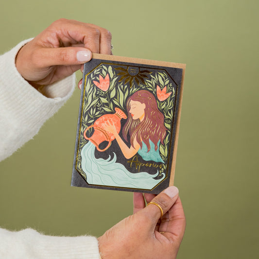 Aquarius Zodiac Garden greeting card held in hand