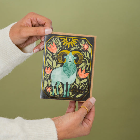 Aries Zodiac Garden greeting card held in hand