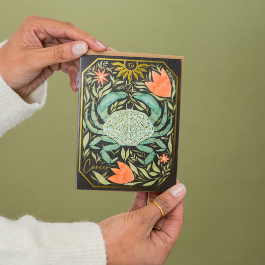 Cancer Zodiac Garden greeting card held in hand