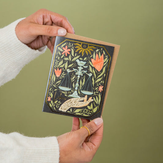 Libra Zodiac Garden greeting card held in hand