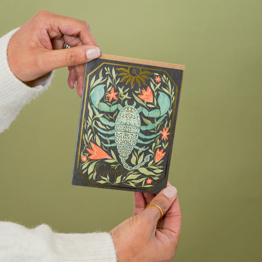 Scorpio Zodiac Garden greeting card held in hand