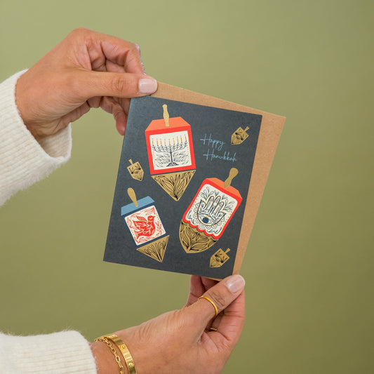 Hanukkah Dreidels greeting card held in hand