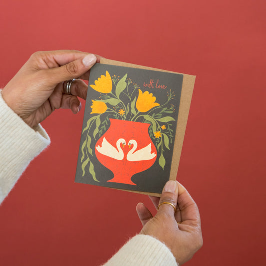 With Love Blooms greeting card held in hand