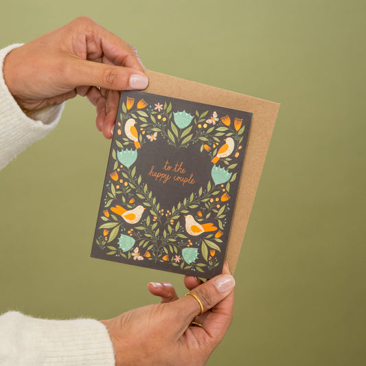 Happy Couple Birds and Flowers greeting card held in hand