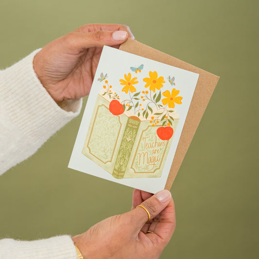 Teacher's Book of Magic greeting card held in hand