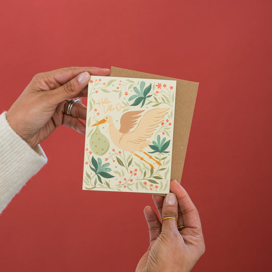 Hello Little One New Baby greeting card held in hand