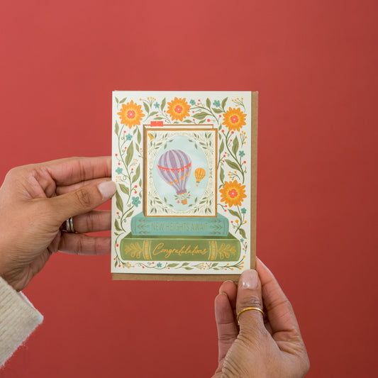 New Heights Await Graduation greeting card held in hand