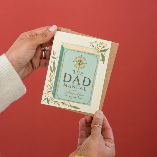 Dad's Manual Father's Day greeting card held in hand