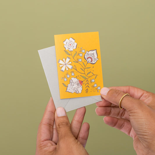 Yellow Ochre Garden mini card held in hand