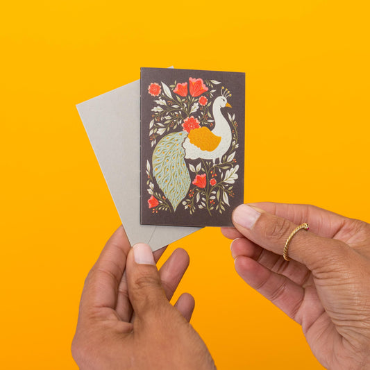 Peacock Garden mini card held in hand