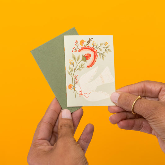 Floral Dove mini card held in hand
