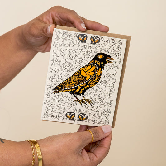 Raven Dark Omens greeting card held in hand