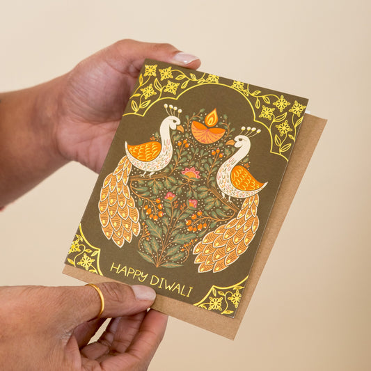 Diwali Birds greeting card held in hand