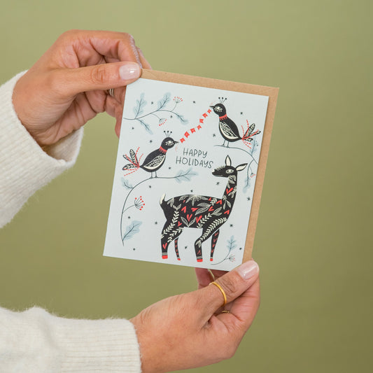 Winter Friends greeting card held in hand