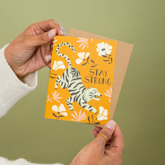 Stay Strong greeting card held in hand