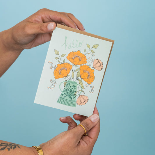 Hello Flowers greeting card held in hand