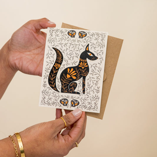 Egyptian Cat Dark Omens greeting card held in hand