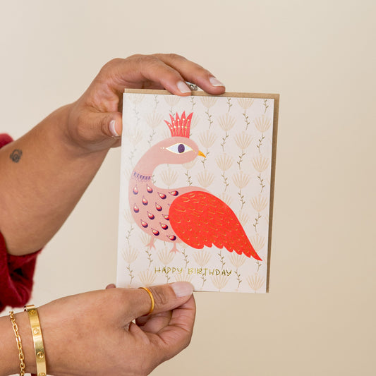 Peacock Birthday greeting card held in hand