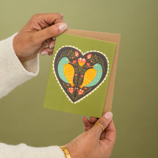 Birds at Heart Love greeting card held in hand