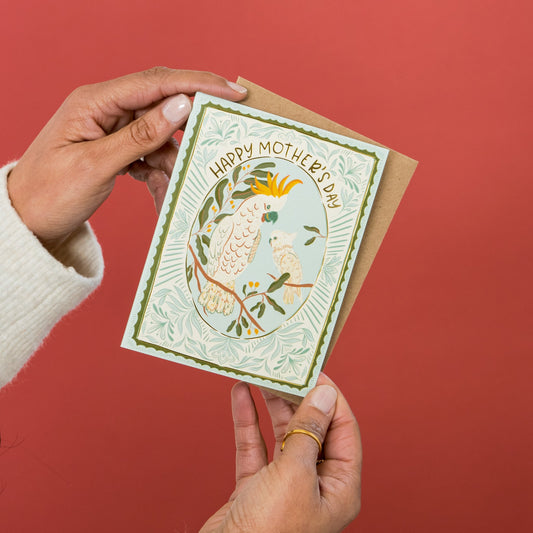 Cockatoo Love Mother's Day greeting card held in hand