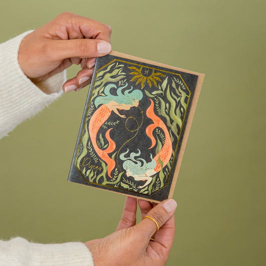 Pisces Zodiac Garden greeting card held in hand