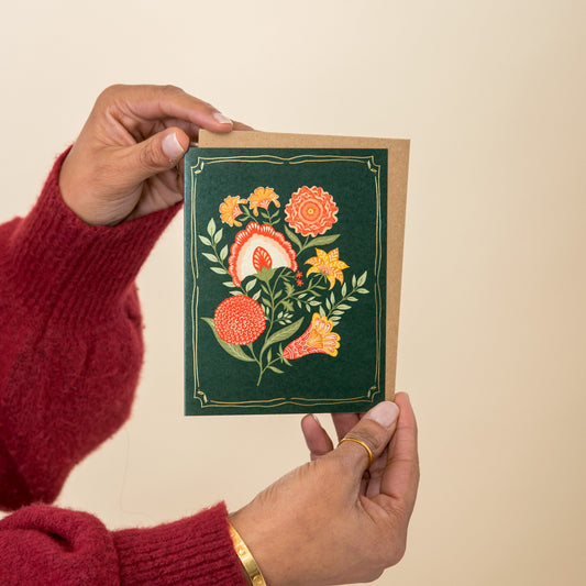 Winter Blooms greeting card held in hand