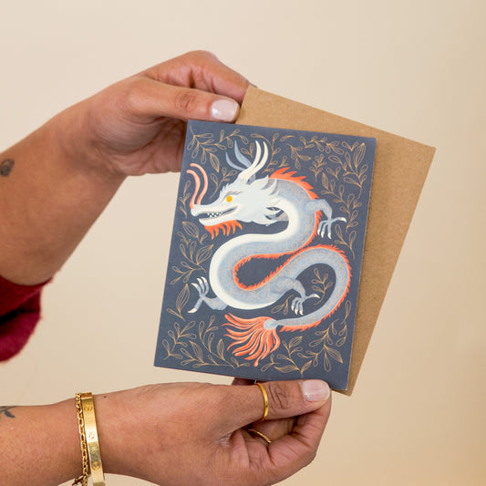 Golden Lunar Dragon greeting card held in hand