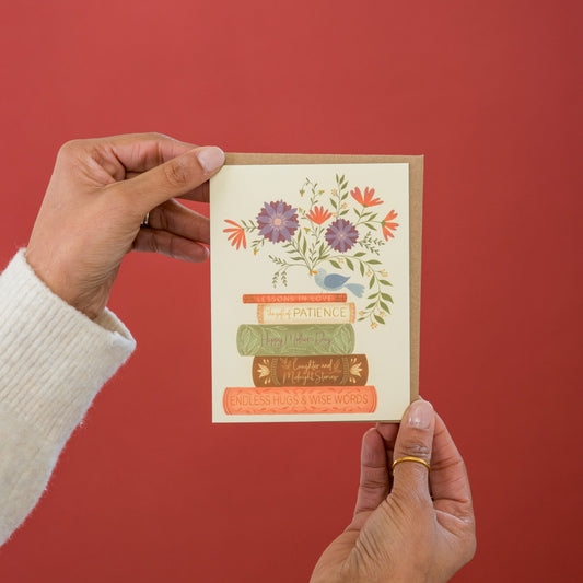 Mom's Library greeting card held in hand