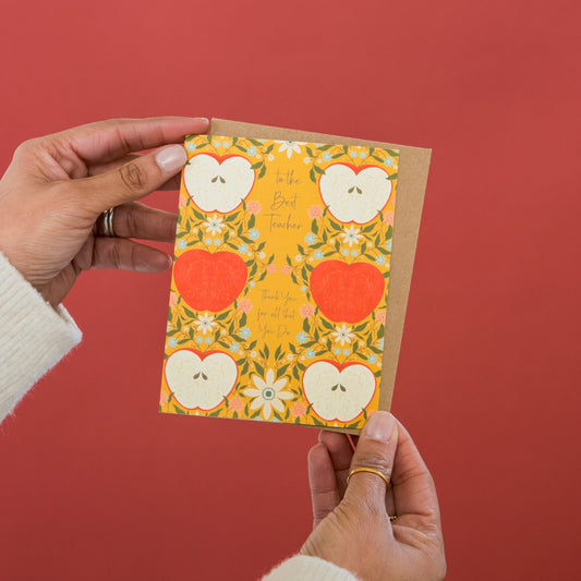 Golden Teacher greeting card held in hand