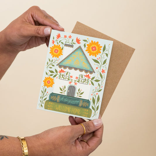 Welcome Home Library greeting card held in hand
