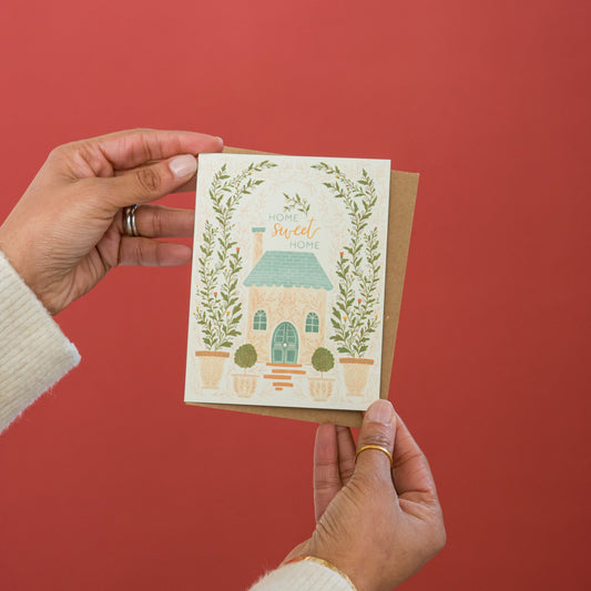 Home Sweet Home Housewarming greeting card held in hand