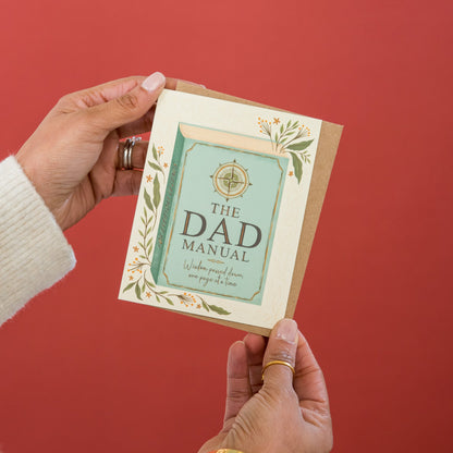 Dad's Manual Father's Day greeting card held in hand