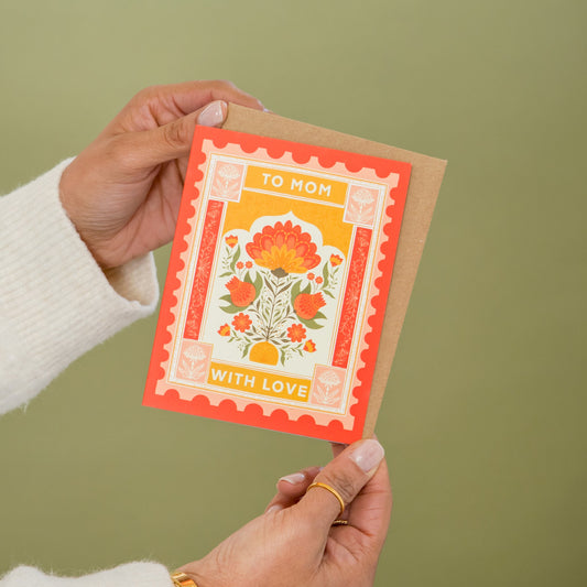 Mom's Postage Mother's Day greeting card held in hand