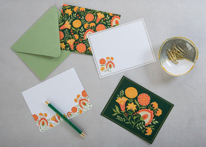 Green Botanicals notecards and envelopes styled on a desk