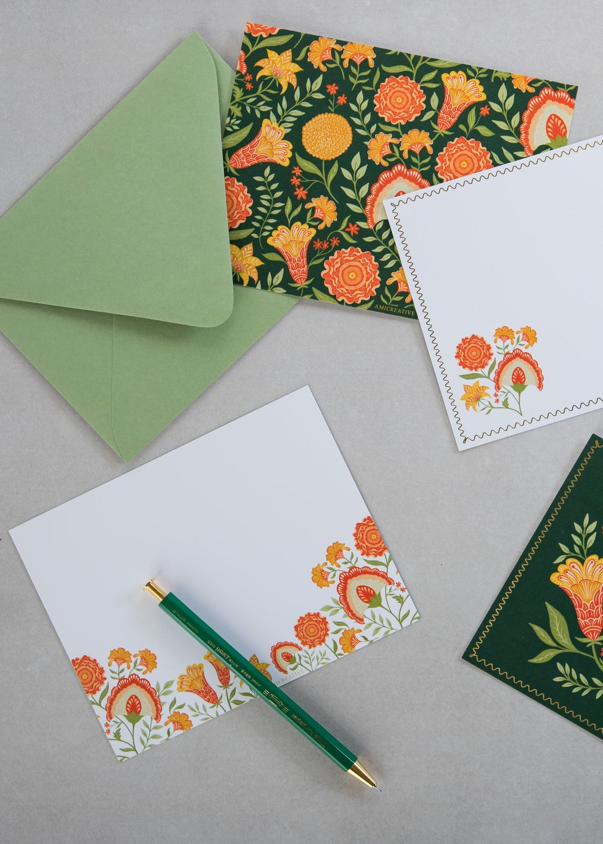 Green Botanicals notecards and envelopes styled on a desk