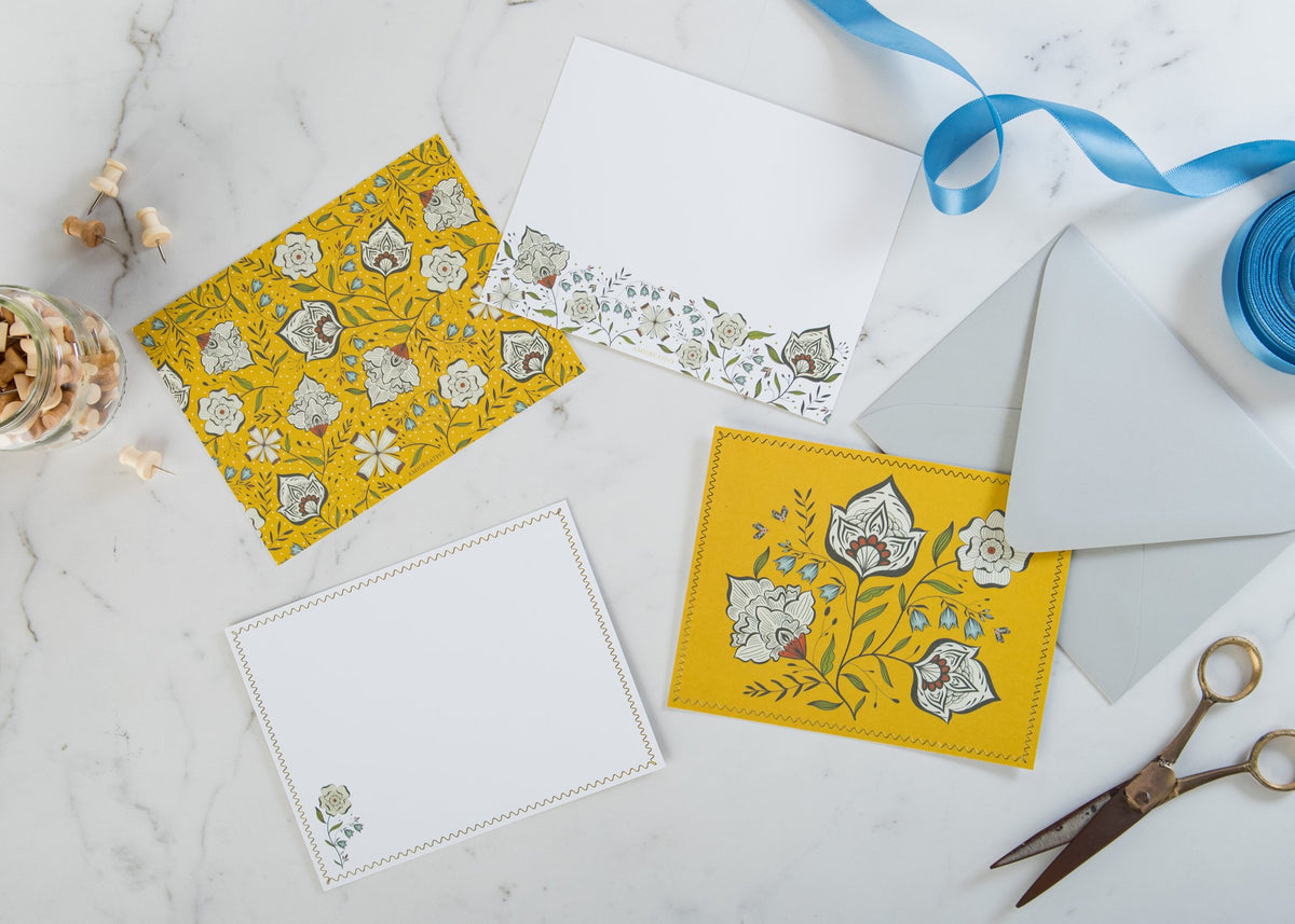 Ochre Garden notecards and envelopes styled on a desk