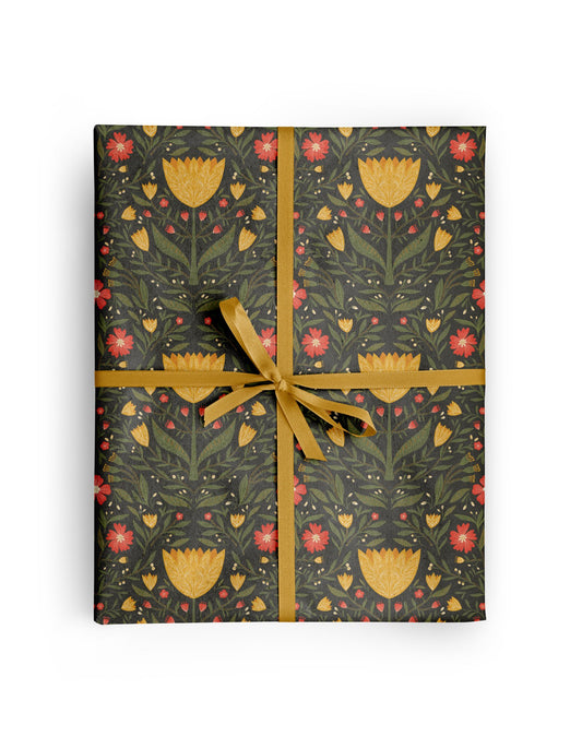 Tulip Garden Wrapping Paper wrapped around a gift, hand-illustrated yellow tulips with red and yellow blooms on charcoal by Amita Nair