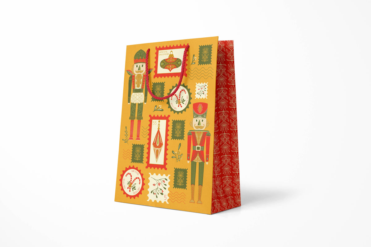 Holiday Stamps Large Gift Bag, hand-illustrated nutcrackers and ornaments as postage stamps on warm yellow by Amita Nair